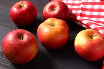 Wall Mural - Red apples on a dark wooden background