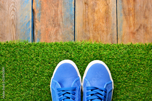 Sneakers Shoes On A Green Grass Footwear Shop Background For A