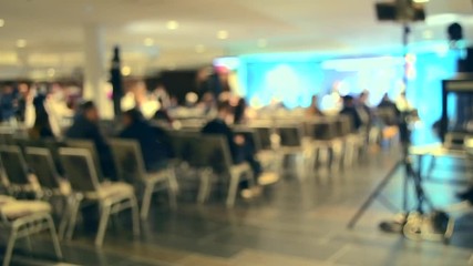 blurred background. many people are sitting in the hall audience listening to presentation lecture s