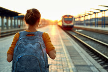 Portrait Of A Young Woman Traveler With Small Backpack On The Railway Stantion