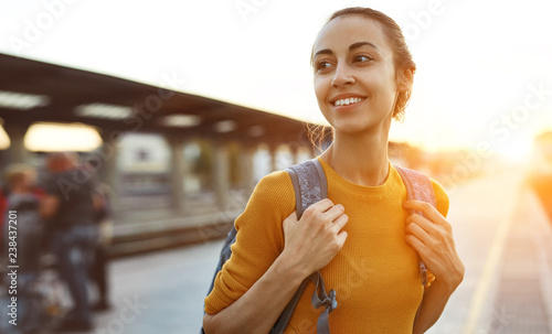 Cuadros en Lienzo portrait of a young woman traveler with small backpack on the railway stantion