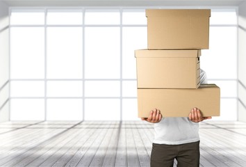 Sticker - Delivery man carrying stacked boxes in front of face against