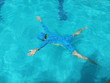 © Chaleow - Little girl in blue tiles pool floating swimming , little girl learning to swim with pool .