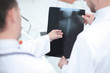 © yurolaitsalbert - close up. diagnoses discussing the x-ray of the patient.rear view