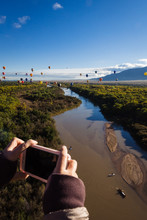 Person Taking A Picture Of Hot Air Balloons