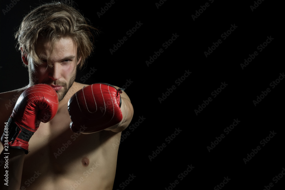 The battle. Professional boxer fighthing isolated in black background ...