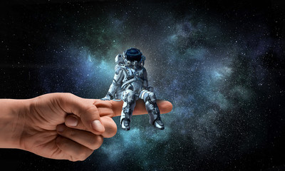Wall Mural - spaceman on finger. mixed media