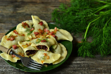 Dumplings Stuffed With Blood Sausage On A Green Plate On A Wooden Background