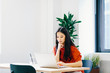 © Cavan Images - Businesswoman using laptop computer while sitting at desk in office