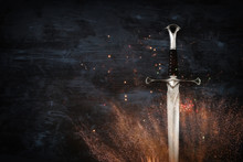 Low Key Image Of Silver Sword With Fire Sparks. Fantasy Medieval Period.