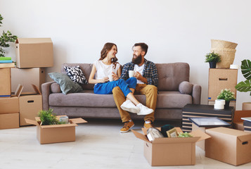 happy young married couple moves to new apartment