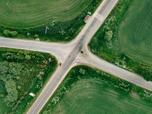 Aerial View Of Empty Road Amidst Agricultural Field