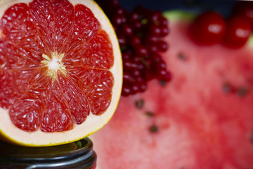 Closeup of summer red healthy organic antioxidant veggies vegetables and fruits: grapefruit, watermelon as symbol of healthy eating, diet and lifestyle. Fridge, vegan. vegetarian and raw concept