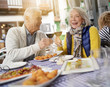 Attractive senior couple eating tapas outdoors