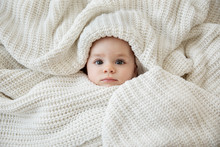 Cute Baby Face Wrapped In Crocheted Blanket