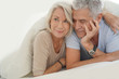 © goodluz - Portait of happy attractive senior couple in bed