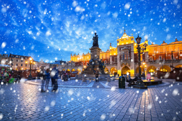 Wall Mural - Old town of Krakow on a cold winter night with falling snow, Poland