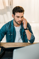 Wall Mural - handsome young man retouching photos at workplace