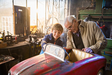 A Grandfather And His Grandson In The DIY Workshop