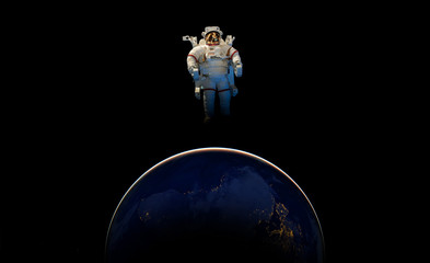 Wall Mural - abstract wallpaper or astronaut flying in outer space near the earth . elements of this image furnis