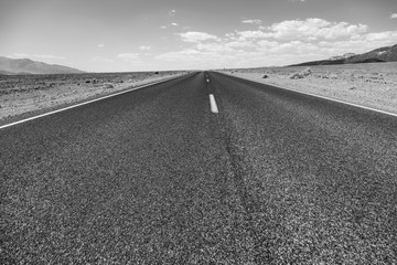 Death Valley road straight across the desert to the mountains in the distance