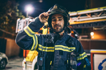 Wall Mural - Fireman man posing to camera.