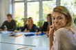 © Westend61 - Portrait of smiling student sitting at table at university