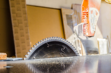 Canvas Print - Circular saw in the carpentry shop. Machine for cutting wood, furniture plates. Production capacity. Employment, job search.