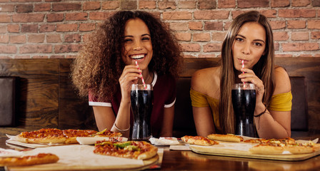 Wall Mural - Female friends having lunch at restaurant