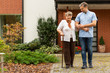 © Photographee.eu - Happy senior lady with walking stick going for a walk in the park with handsome volunteer