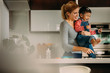 © Jacob Lund - Mother and son enjoying while baking cookies in kitchen