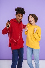 Wall Mural - Cheerful multhiethnic teenage couple standing together