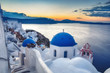 © Funny Studio - Beautiful view of Santorini island in Greece at sunrise with dramatic sky.