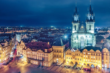 Wall Mural - Aerial view on Old town with Tyn church in Prague, Czech republic, at night. Colourful skyline.