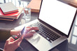 © olgapogorelova - Closeup view woman hands using mobile smartphone and laptop. Space for design layout. Loft interior daylight.