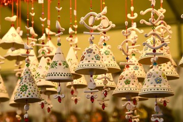 Wall Mural - Florence, ITALY - DECEMBER 2018: small decorated bells hanging from the roof at the Christmas market in front of the 'Basilica of Santa Croce'. Christmas 