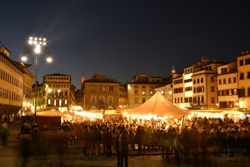 Wall Mural - Florence, ITALY - 8th December 2018: Tourists at Christmas Market in the centre of Florence near Basilica of Santa Croce. Christmas atmosphere with Sparkling lights, Italy.