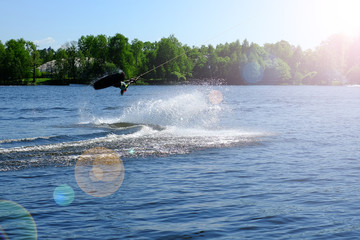 Athlete wakeboarder performs a jump with a somersault in the air