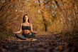 © Kate - Young woman practicing yoga exercise in autumn park with yellow leaves. Sports and recreation lifestyle