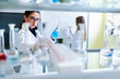 © lordn - Chemistry and medicine students working in a laboratory. Young female researchers doing lab tests.
