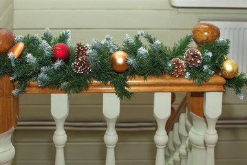 Christmas decoration lies on the wooden railing.