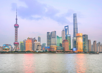 Fototapete - Illuminated Shanghai skyline at twilight