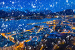 Alesund town on a cold winter night with falling snow, Norway