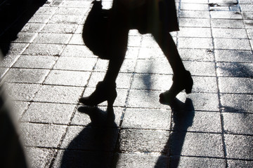 Wall Mural - Blurry legs of young woman walking