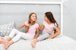 © be free - Children relax and having fun in evening. Sisters leisure. Girls in cute pajamas spend time together in bedroom. Sisters communicate while relax in bedroom. Family time. Sisters communication