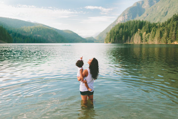 A mother and daughter exploring a beautiful lake in the mountains