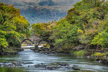 Wall Mural - Old Weir Bridge, Meeting of the Waters, where the three Killarney lakes (Upper, Muckross and Lough Lane) meet Killarney National Park, County Kerry, Ireland.