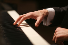 Hands On Piano. The Pianist Plays The Piano. Piano Keys On Black Background