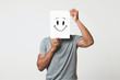 © Prostock-studio - Black man holding paper with smiley face