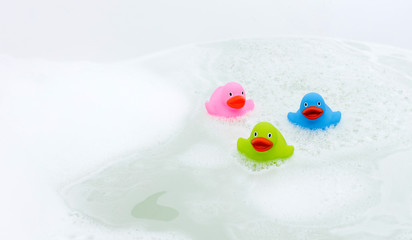 Wall Mural - Pink, green and blue duck in a bathtub